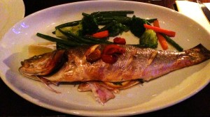 Spigola al Forno: Oven baked whole sea bass with garlic, cherry tomates, rosemary and white wine served with daily vegetales.